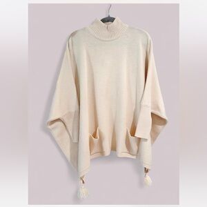 Vtg 100% Merino Wool Cream Mockneck poncho sweater with pockets & tassel hem